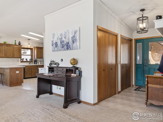 interior space featuring ornamental molding, sink, a textured ceiling, and an inviting chandelier