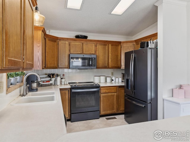 kitchen with sink, ornamental molding, pendant lighting, stainless steel appliances, and decorative backsplash