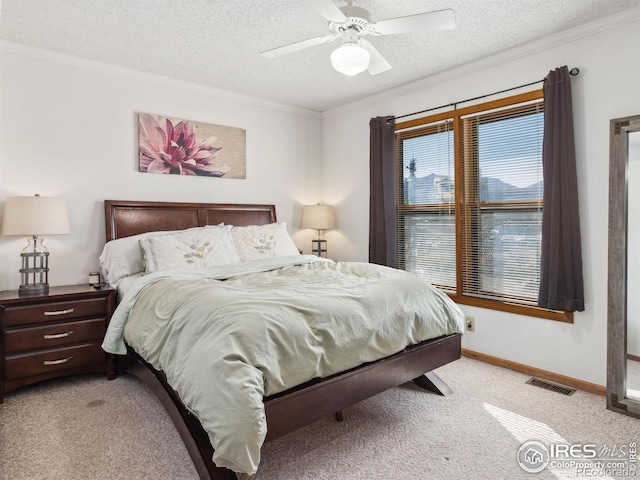 bedroom with crown molding, light colored carpet, and a textured ceiling