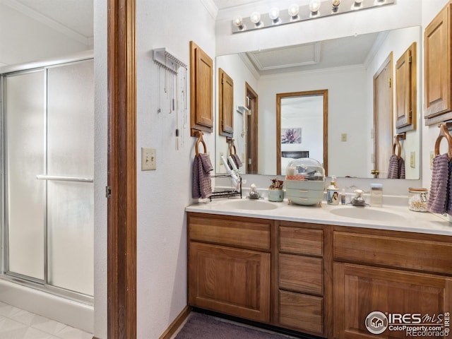 bathroom with crown molding, vanity, and a shower with door