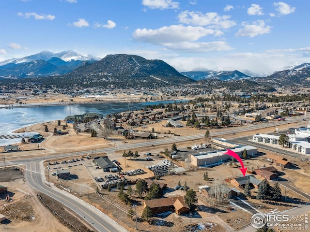 birds eye view of property with a water and mountain view