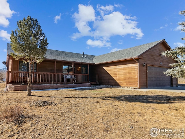 ranch-style home with a porch and a garage