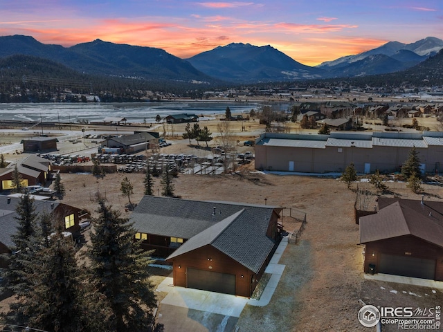 aerial view at dusk featuring a mountain view