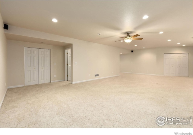 carpeted spare room with ceiling fan