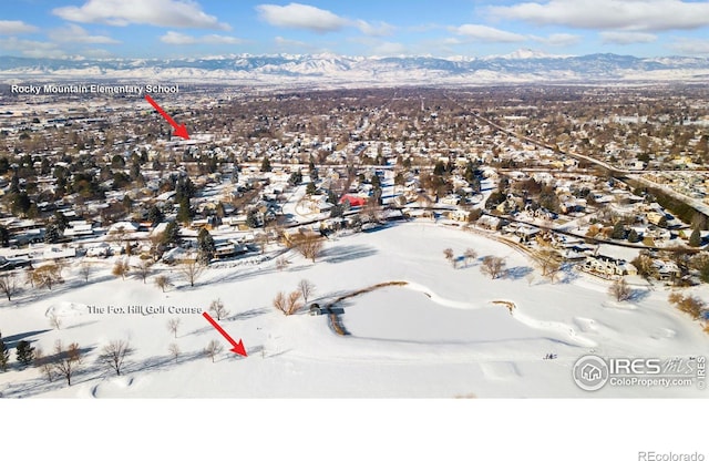 snowy aerial view with a mountain view