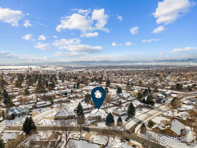 snowy aerial view featuring a mountain view