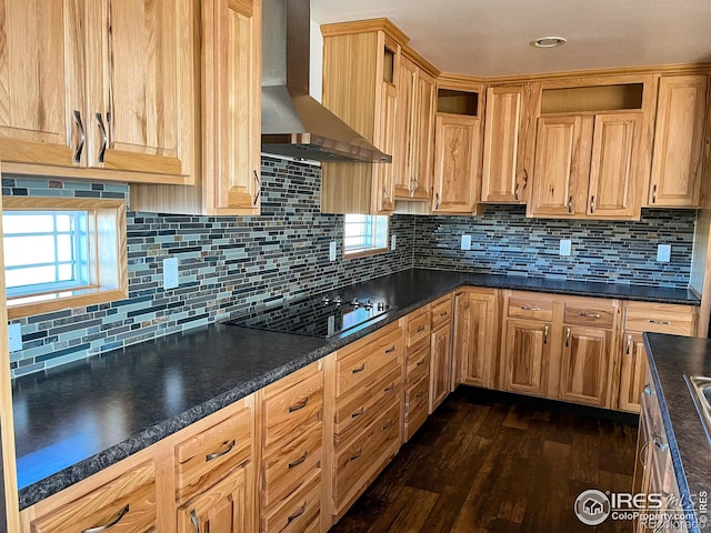 kitchen featuring dark wood-type flooring, black electric stovetop, decorative backsplash, and wall chimney exhaust hood