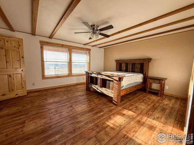 unfurnished bedroom with ceiling fan, hardwood / wood-style floors, and beam ceiling