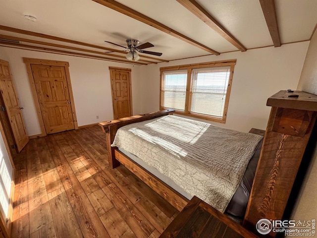 bedroom with hardwood / wood-style flooring, ceiling fan, and beam ceiling