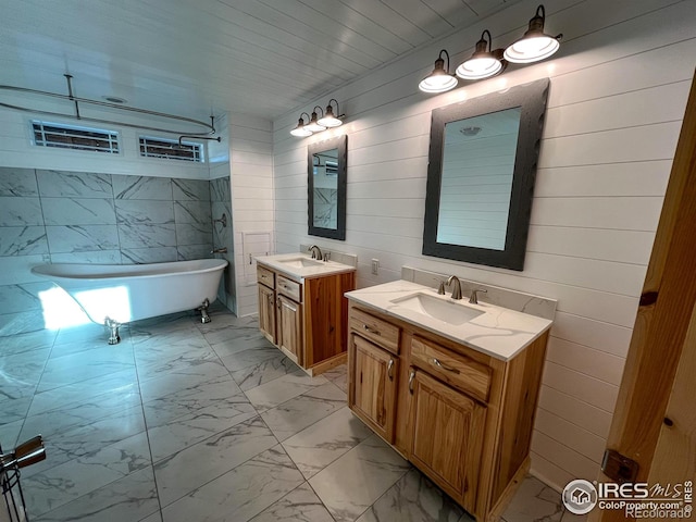 bathroom with vanity and a bath