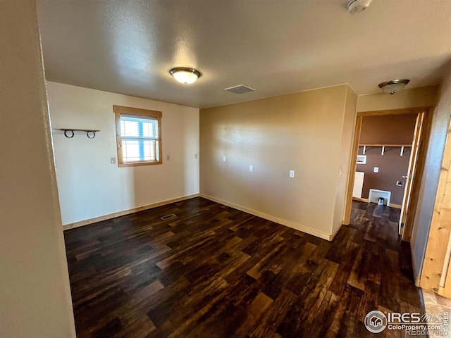 unfurnished room featuring dark hardwood / wood-style flooring