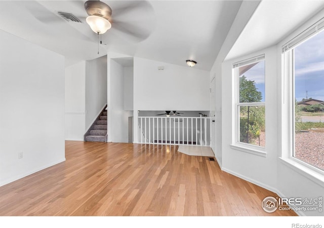 spare room with ceiling fan and light wood-type flooring