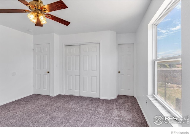 unfurnished bedroom featuring carpet floors, ceiling fan, and a closet