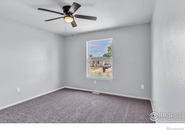 carpeted empty room featuring ceiling fan