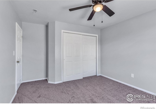 unfurnished bedroom featuring carpet flooring, ceiling fan, and a closet