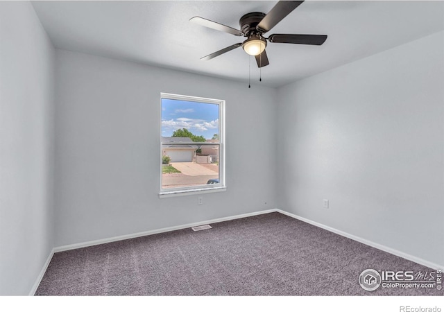 carpeted empty room featuring ceiling fan