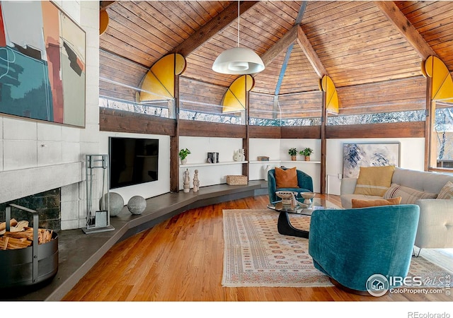 living room with hardwood / wood-style flooring, a fireplace, wood ceiling, and beam ceiling