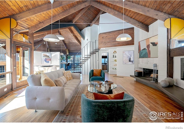 living room with wood ceiling, a healthy amount of sunlight, a fireplace, and wood-type flooring