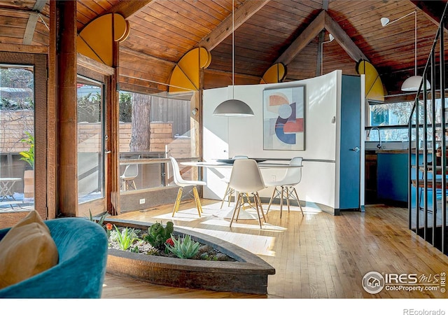 sunroom / solarium featuring vaulted ceiling with beams and wood ceiling