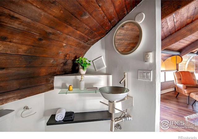 details featuring beam ceiling, sink, wood ceiling, and wood-type flooring