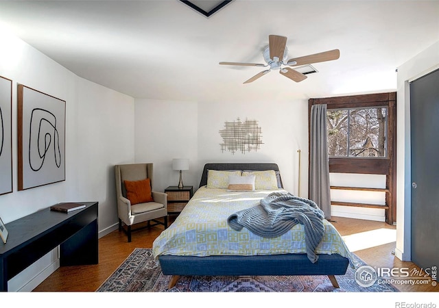 bedroom with hardwood / wood-style flooring and ceiling fan