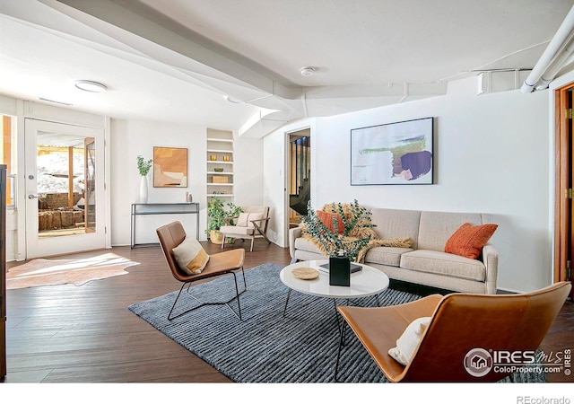 living room with lofted ceiling, dark wood-type flooring, and built in features