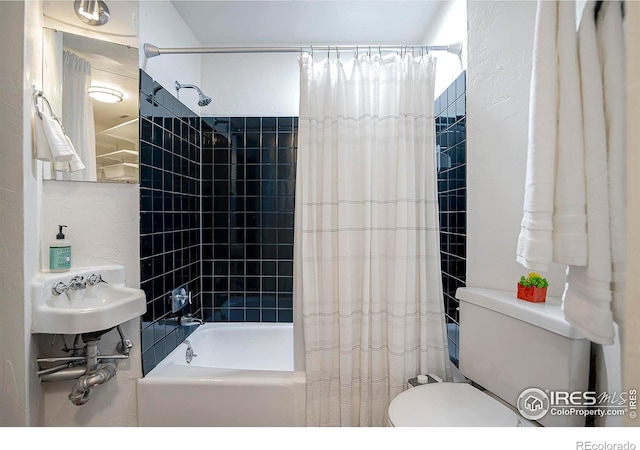 full bathroom with toilet, sink, and shower / bath combo with shower curtain