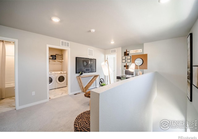 kitchen with light colored carpet and washing machine and dryer