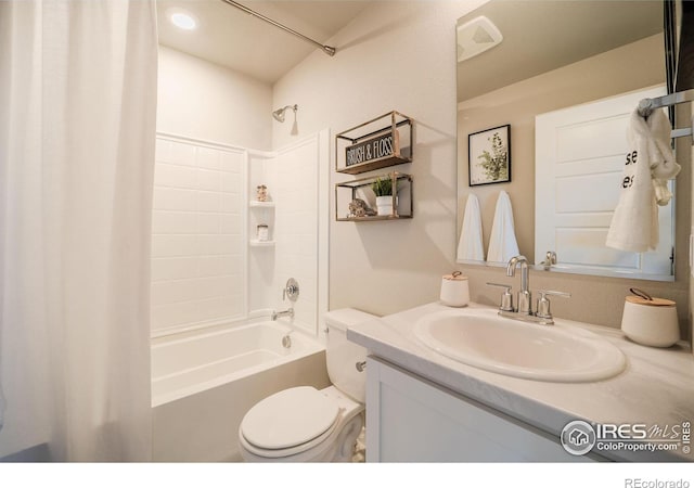 full bathroom featuring shower / tub combo with curtain, vanity, and toilet