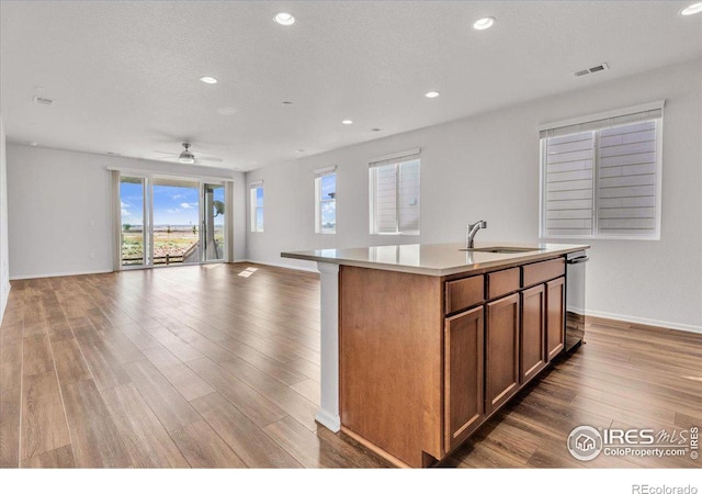 6508 Copper Dr, Frederick, CO 80516 - kitchen featuring a sink, wood finished floors, open floor plan, dishwasher, and recessed lighting