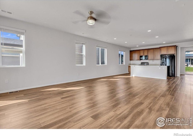 6508 Copper Dr, Frederick, CO 80516 - unfurnished living room featuring ceiling fan, wood finished floors, recessed lighting, and baseboards