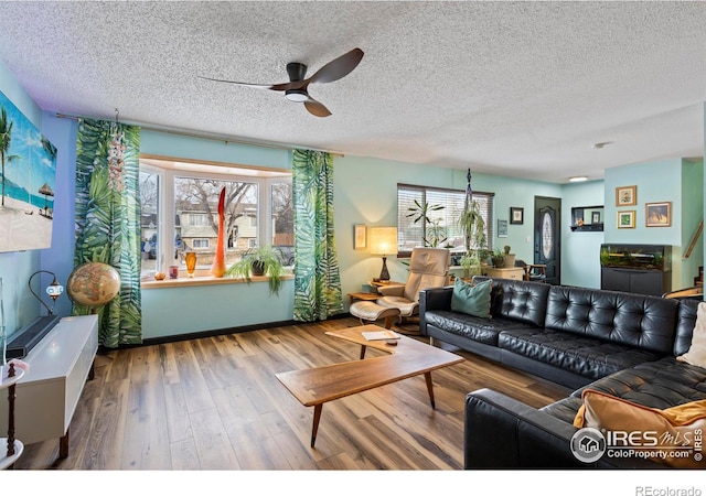 living room featuring plenty of natural light, hardwood / wood-style floors, and a textured ceiling