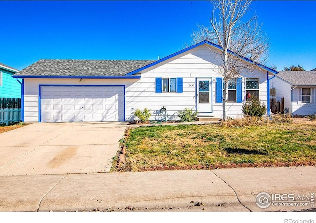 ranch-style home with a garage and a front lawn