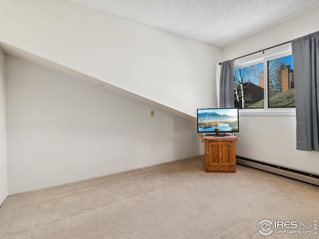 interior space featuring a baseboard radiator, light carpet, and a textured ceiling