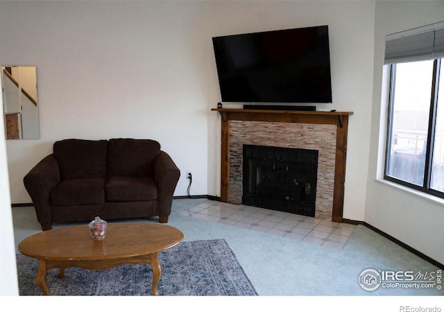 carpeted living room featuring a tile fireplace and a wealth of natural light