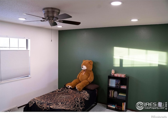 bedroom featuring ceiling fan and carpet