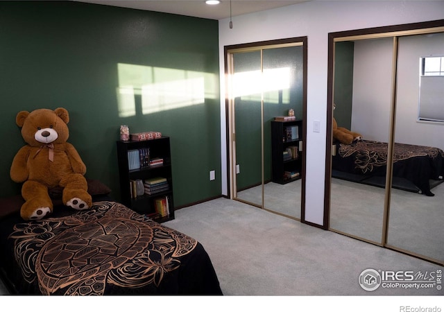 carpeted bedroom featuring two closets