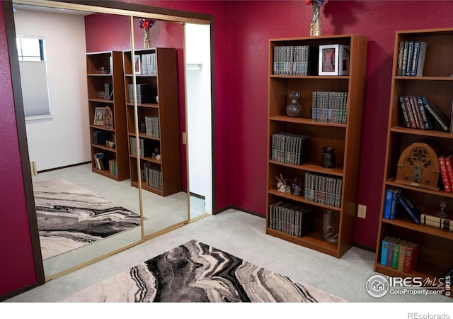 sitting room featuring light colored carpet