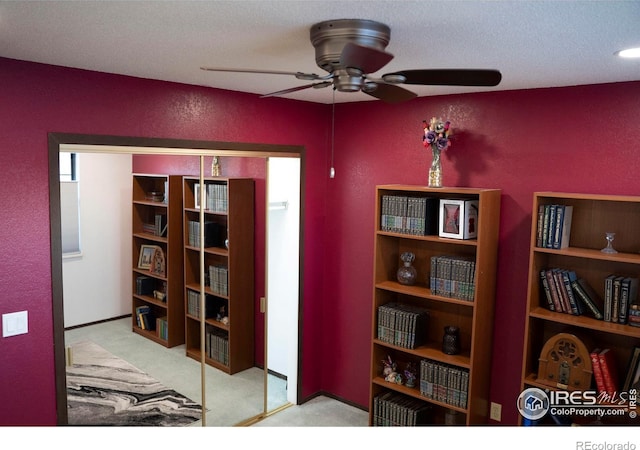 interior space with light colored carpet and ceiling fan