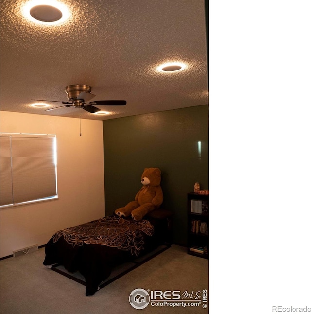 bedroom featuring carpet floors and a textured ceiling