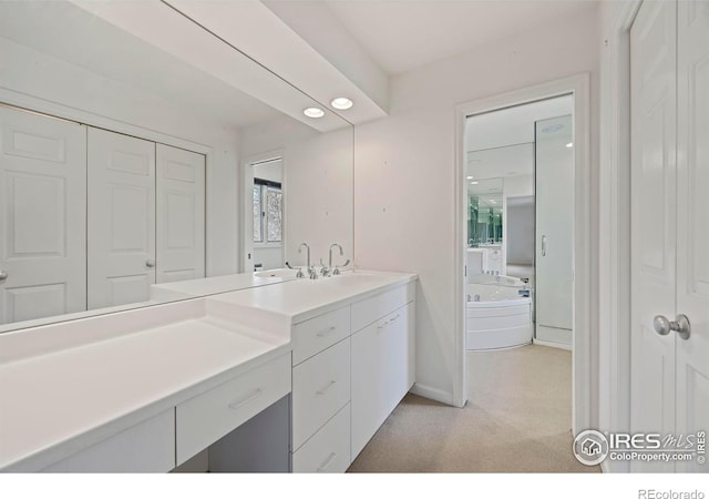 bathroom with vanity and a bath