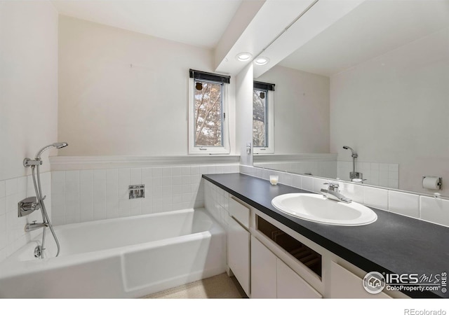 bathroom with vanity and a bathtub