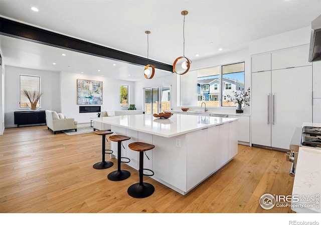 2125 Vine Ave, Boulder, CO 80304 - kitchen featuring modern cabinets, white cabinets, light wood-style flooring, recessed lighting, and open floor plan