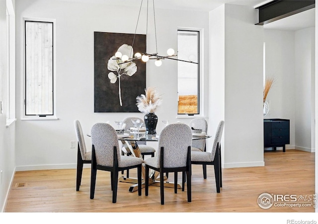2125 Vine Ave, Boulder, CO 80304 - dining space featuring wood finished floors, baseboards, and a chandelier