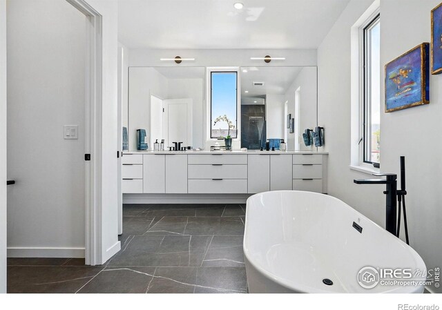 2125 Vine Ave, Boulder, CO 80304 - full bathroom with vanity, a soaking tub, baseboards, recessed lighting, and tile patterned flooring