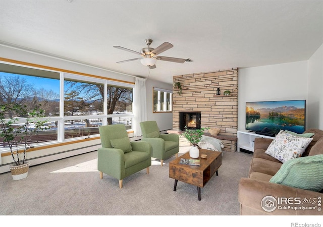 living room featuring a fireplace, a ceiling fan, carpet, and a baseboard radiator