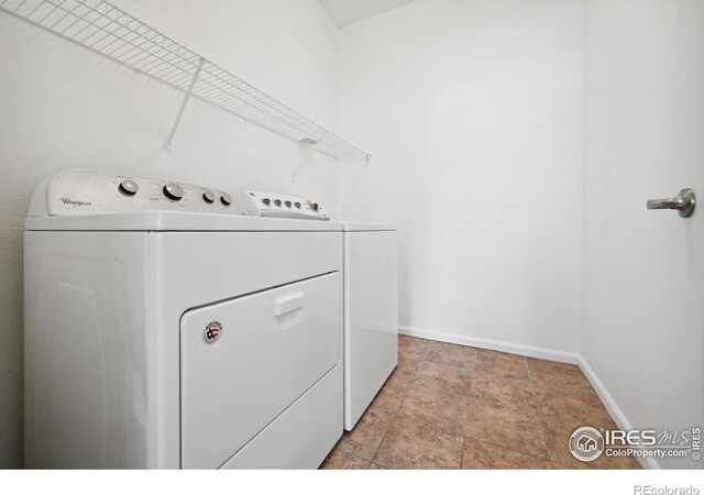 clothes washing area with washer and clothes dryer