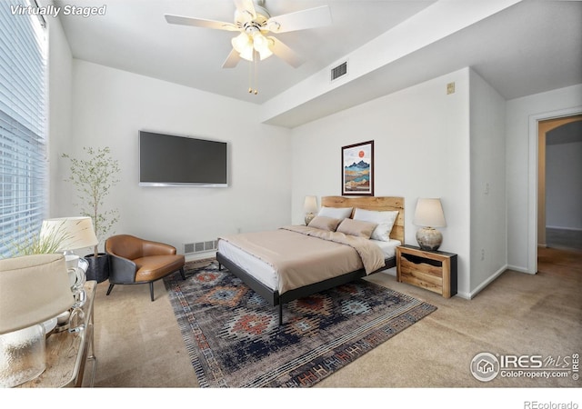 bedroom with light colored carpet and ceiling fan