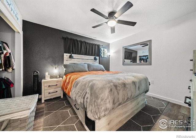 bedroom with ceiling fan and a closet