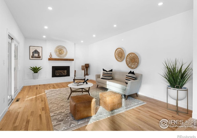 living room with hardwood / wood-style floors and a fireplace